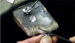 The manufacturing process of a quality Paris jewellery is specialized. Each artisan jeweller has a specific task. Here, the jeweler filing a raw piece of jewelry in Paris