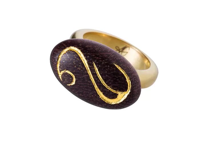 22 carat gold and wood ring 22 carat gold and wood ring encarved and decorated with gold leave.
