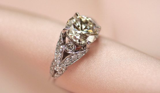 Custom made romantic engagement ring in white gold set with diamonds