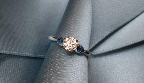 This classic white gold engagement ring features a diamond and two drop-shaped sapphires. It was made in Paris by Annette Girardon.
