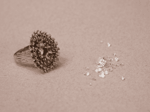 Pierres prelevées dans une ancienne bague pour en faire une nouvelle Cette bague ancienne en or blanc, sertie de multiples diamants dur griffes dans un assemblage en losange à été apportée pour une transformation de bijou à l'artisan joaillier Annette Girardon.