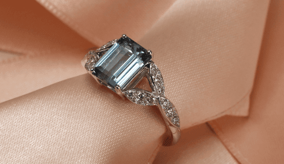 fiancailles-surprenante Une aiguemarine Santa Maria Africana est tenue d'une manière originale par des losanges en or blanc, pavés de diamants. Cette bague de fiançailles unique.