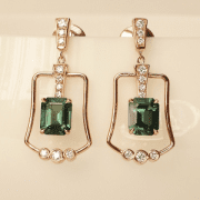 Une paire de boucles d'oreilles en or rouge avec des tourmalines en taille émeraude et des diamants.
