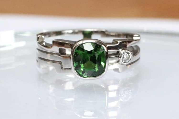 herren-designer-schmuck Dieser Herrenring aus Platin, besetzt mit einem Tsavorit und einem Diamanten, wurde von der Welt der Comics inspiriert und von der talentierten Juwelierin Annette Girardon in Paris entworfen.