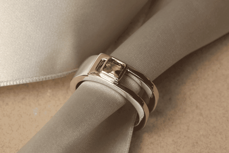 men's-French-jewelry The square green stone on this men's ring, set in a platinum band, is a peridot. Annette Girardon is a trendy men's jewelry brand.