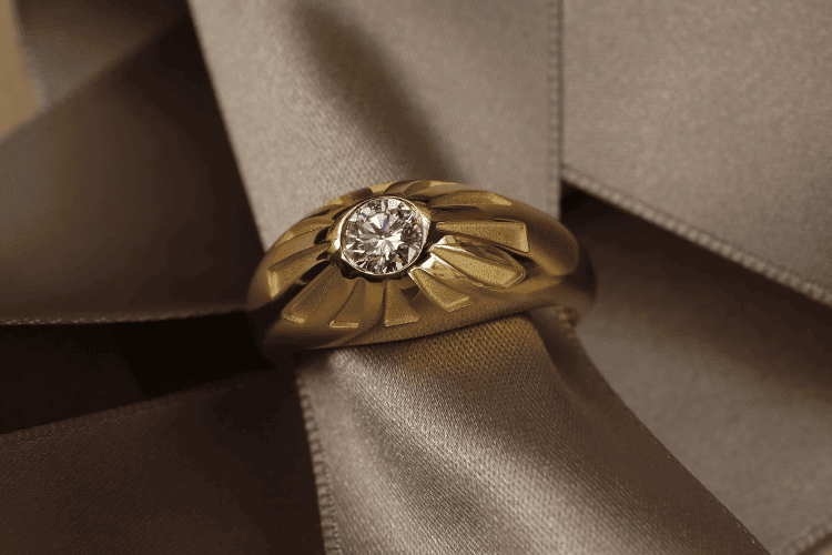 signet-ring-with-diamond This signet ring is a men's ring, made of 18-carat yellow gold, crafted in Paris. A 0.57 ct diamond adorns the top of this conical ring. It is a custom-made creation by Annette Girardon.